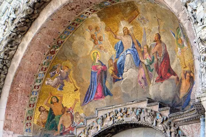 Intricate mosaic depicting religious figures on St. Mark's Basilica, Venice, featured in the guided tour experience.