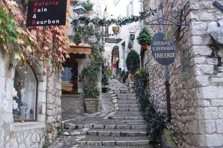 Charming stone stairway alley in St Paul de Vence with boutique shops and holiday greenery decorations