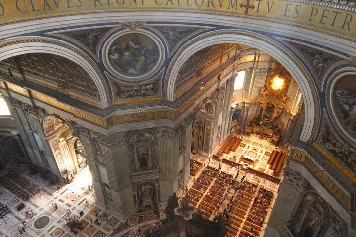 Aerial view of St. Peter's Basilica interior showcasing ornate architecture and opulent design, ideal for dome climb tour.