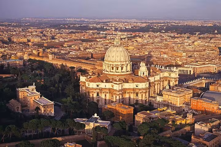 Aerial view of St. Peter's Basilica in Vatican City, ideal for Rome tour featuring the dome climb and underground exploration.