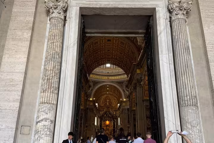 Entrance to St. Peter's Basilica showcasing intricate architecture on a Vatican small group private tour.