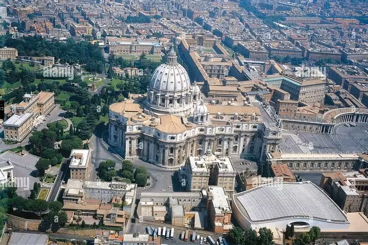 Aerial view of St. Peter's Basilica surrounded by lush gardens and Vatican City, ideal for exploring the Vatican's beauty.