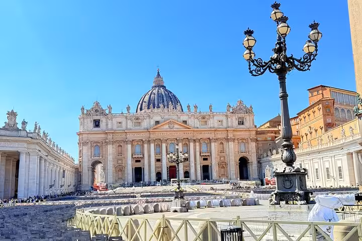 Magnificent exterior of St Peter's Basilica under blue skies, a highlight of the Vatican small group private tour.