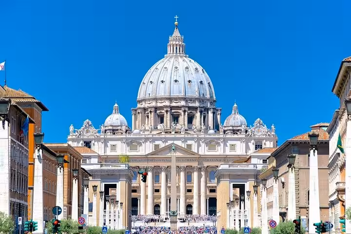 Majestic front view of St. Peter's Basilica under a clear blue sky, ideal for Vatican City tours and exploration.