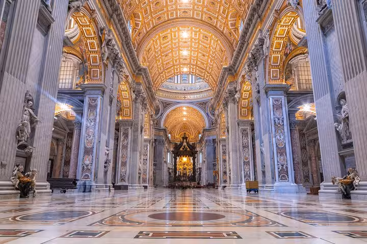 Lavishly decorated interior of St. Peter's Basilica with ornate ceilings and grand columns, perfect for a Vatican tour.