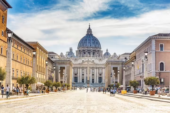 View of St Peter’s Basilica from Via della Conciliazione filled with tourists on a Vatican Papal Audience and Sistine Chapel tour