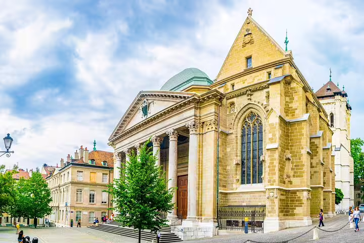 St. Peter's Cathedral in Geneva's Old Town with neoclassical facade and Gothic stonework under cloudy sky