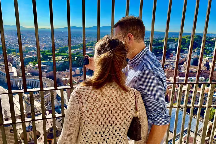 Couple enjoying private early morning views of Rome from the top of St Peter’s Basilica dome on a VIP guided tour