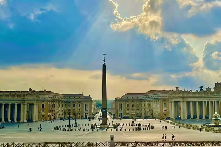 Panoramic view of St Peter’s Square and Vatican obelisk in Rome under dramatic sky on a private Colosseum and Vatican tour