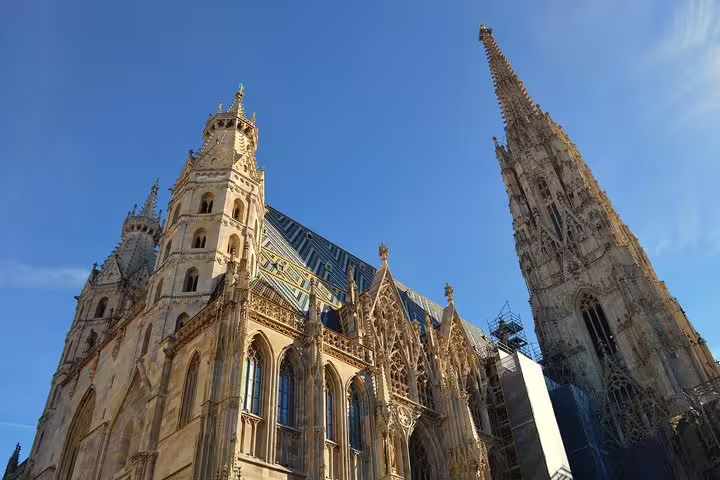 St. Stephen's Cathedral Gothic spire and ornate facade under blue sky in Vienna