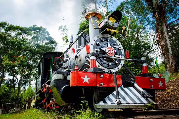 Vintage steam locomotive number 68 traveling through scenic landscapes on the Gold Route tour.