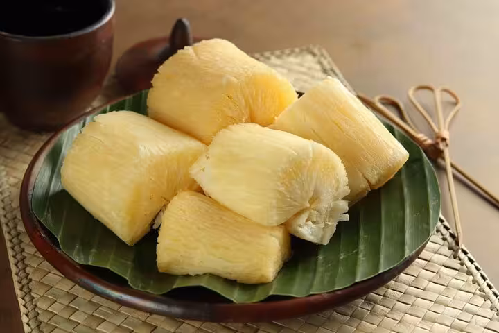 Steamed cassava on banana leaf, a staple dish in Rio's Cookin' Good culinary tour, showcasing local Brazilian flavors.