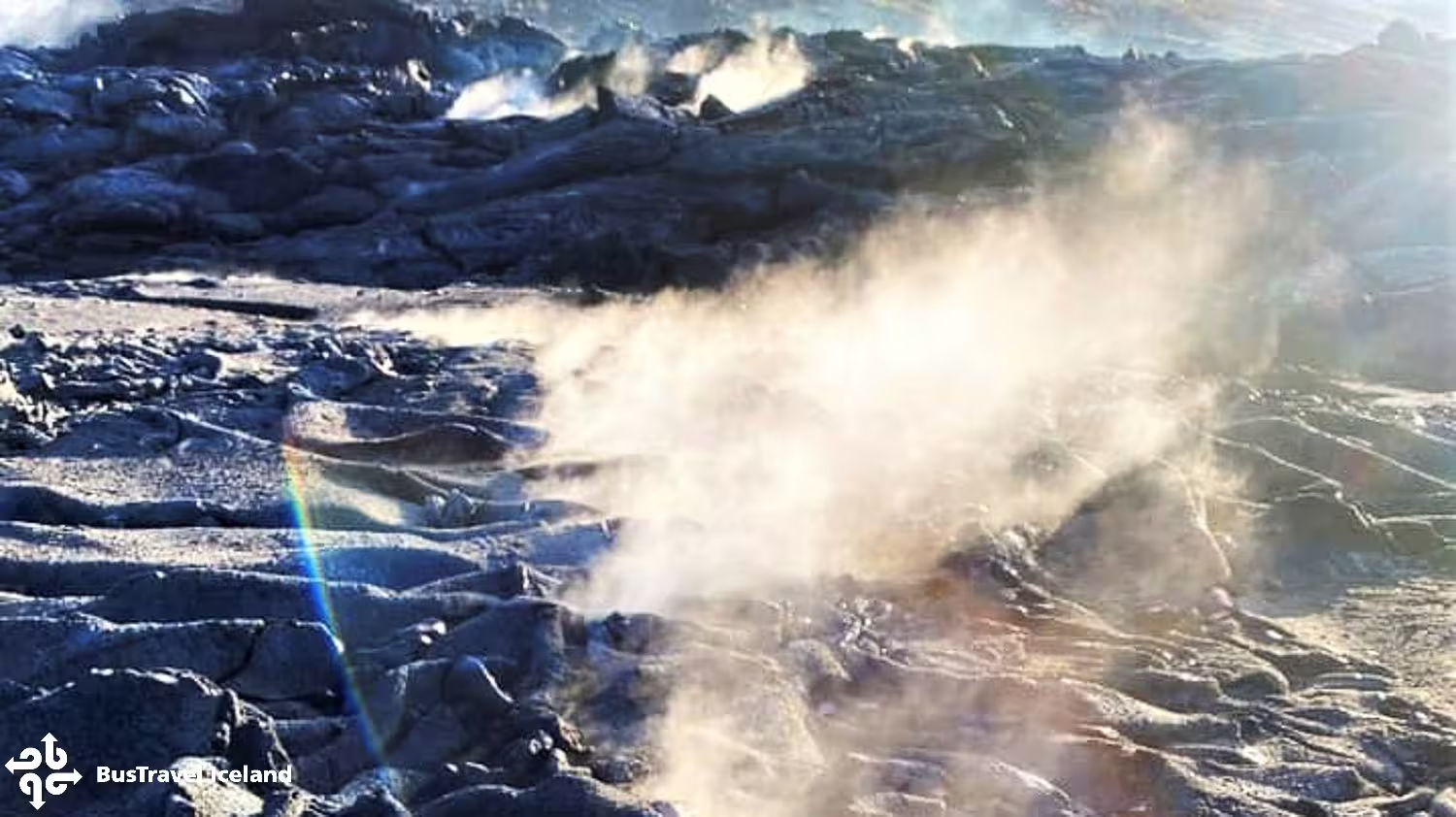 Steam rising from cooling lava fields on Iceland volcano hike near Reykjavik