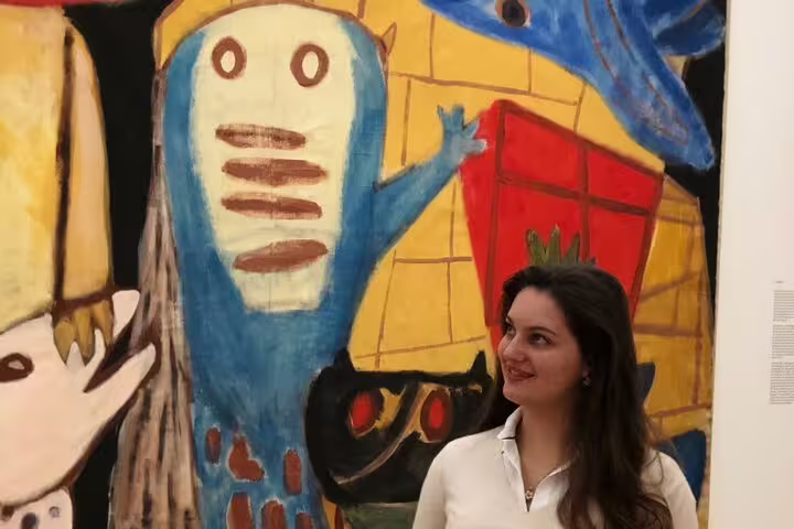 Visitor viewing bold modern painting at Stedelijk Museum Amsterdam, contemporary art and inspirations tour stop