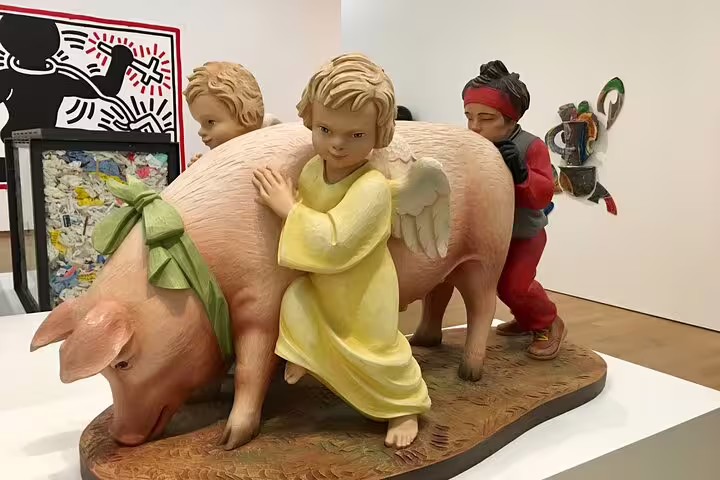Whimsical sculpture at Stedelijk Museum Amsterdam, contemporary art tour highlight with playful figures and pig