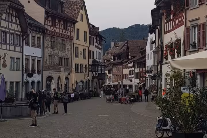 Scenic cobblestone street in Stein am Rhein with traditional architecture, a highlight of the Rhine Falls private tour.