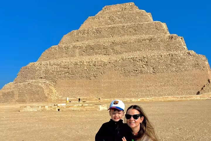 Visitors posing by the Step Pyramid of Djoser at Saqqara on a private Cairo day tour with lunch included
