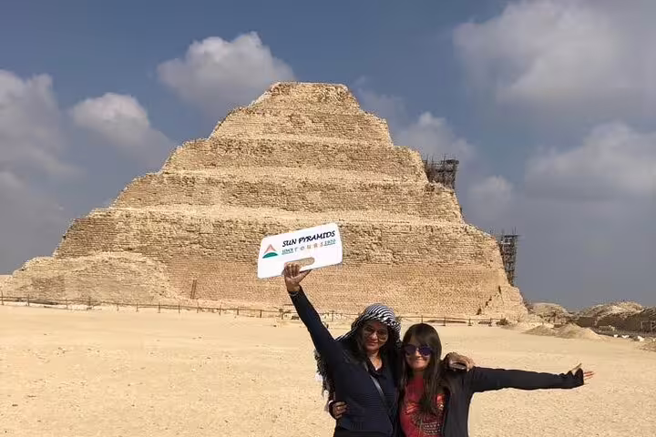 Travelers posing by the Step Pyramid of Djoser in Saqqara on private guided tour with lunch and transfers