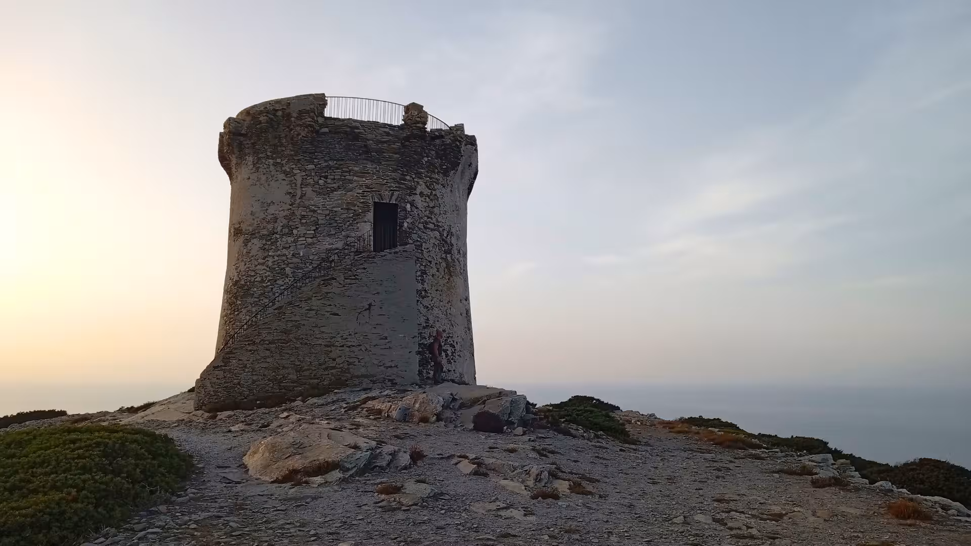 Ancient stone tower at Capo Falcone with a sunset backdrop, showcasing the allure of Stintino's sunset hiking tour.