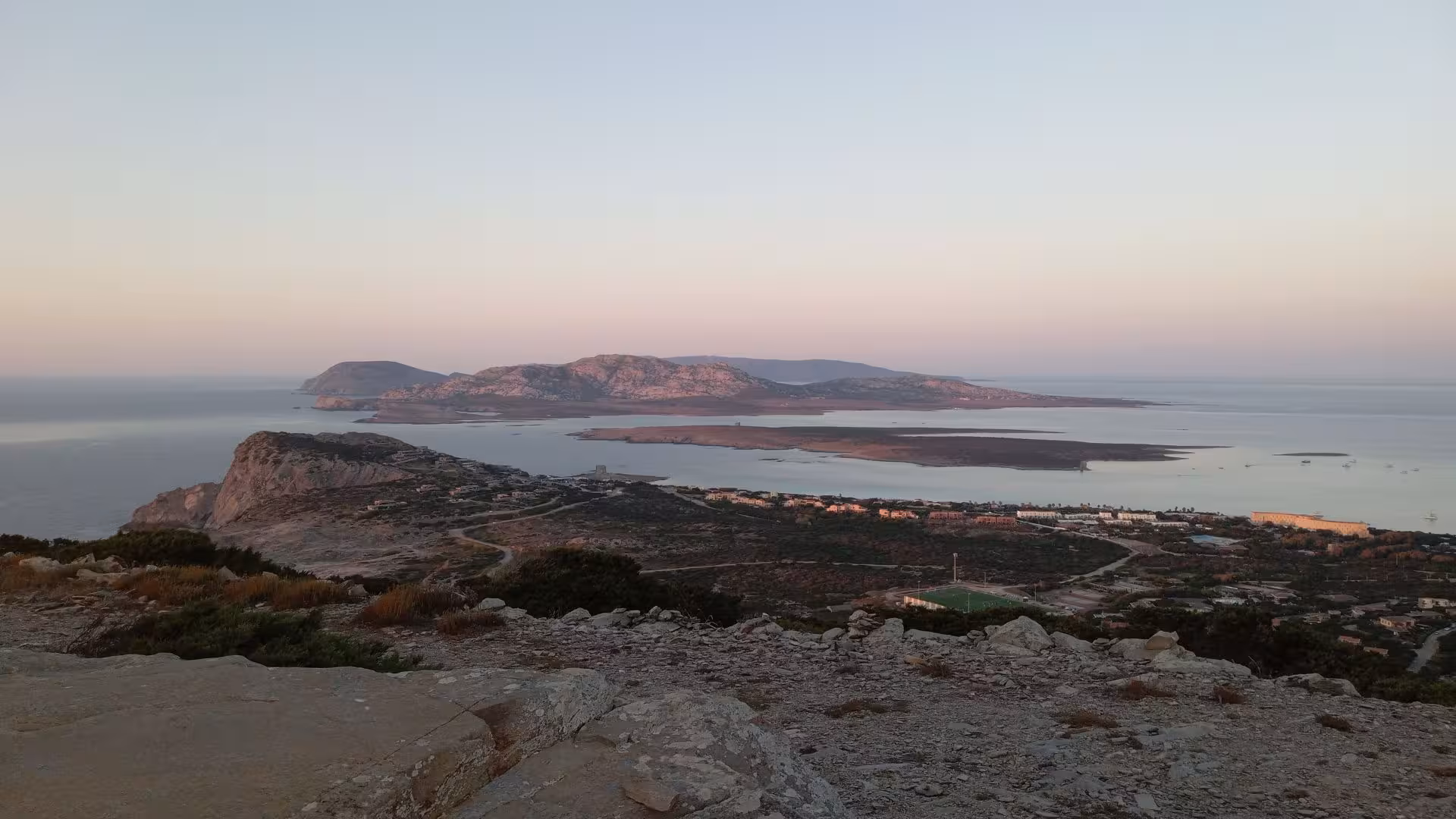 Scenic view of Capo Falcone with a stunning sunset over Stintino coastline, ideal for a sunset hike and tasting tour.