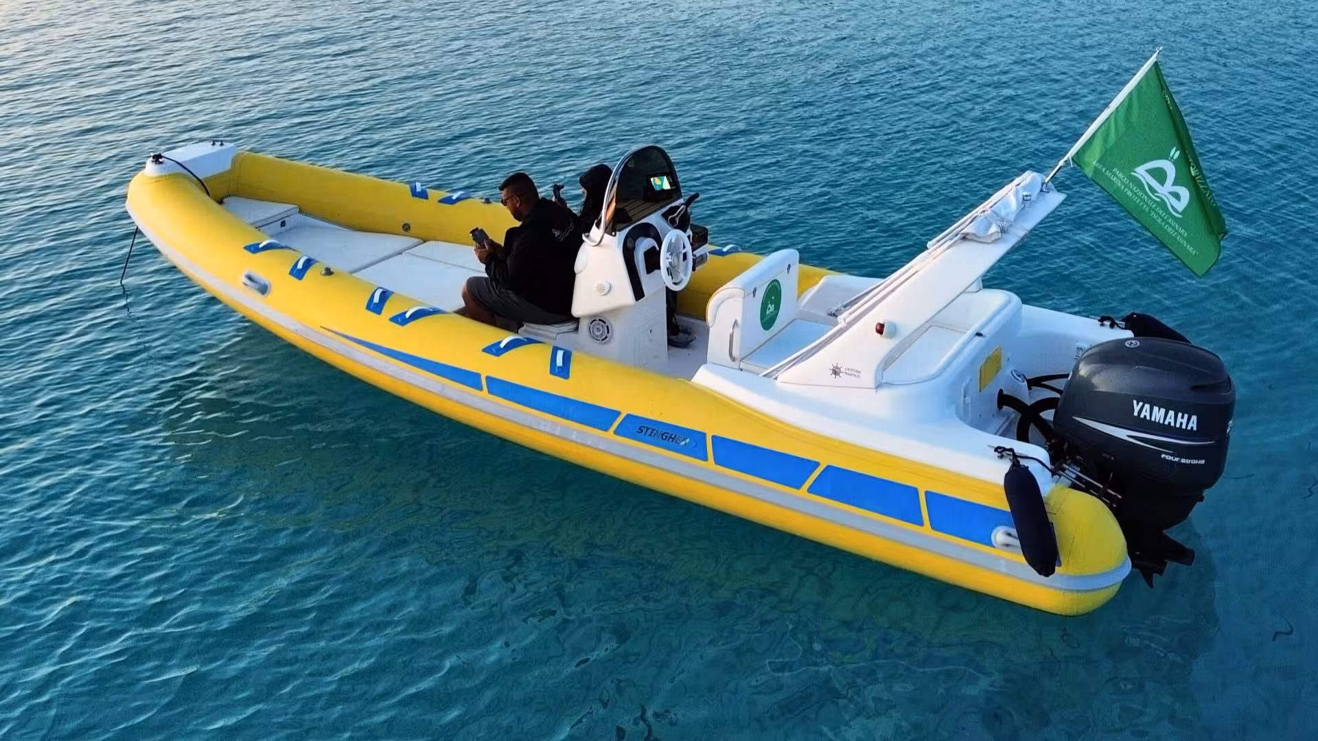 A vibrant yellow dinghy floats on clear blue waters, ideal for a Stintino two-hour sunrise or sunset tour.