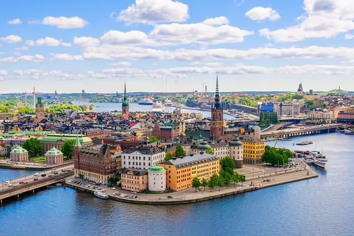 Aerial view of Stockholm Old Town (Gamla Stan) surrounded by blue water with historic buildings and church spires