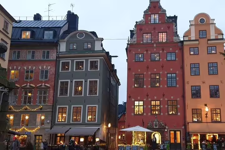 Colorful historic buildings at Stortorget square in Stockholm's Old Town at dusk with festive lights