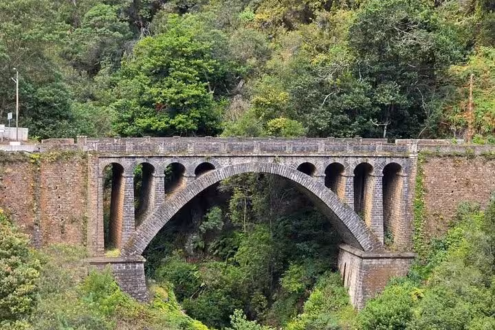 Old stone arch bridge in Madeira’s lush valley on the Pico do Areeiro to Ponta São Lourenço 4x4 expedition