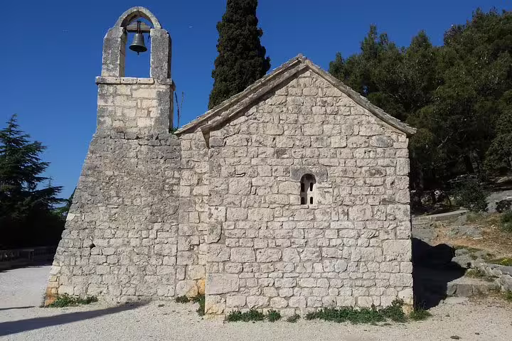 Stone chapel with bell tower on Marjan Park trail, a highlight of the Secret Marjan Park Hiking Tour in Split