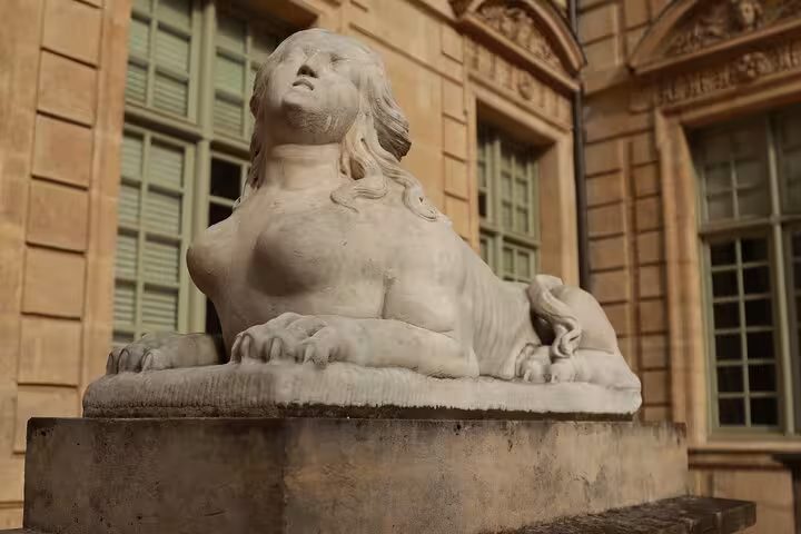 Stone sphinx statue in a Paris courtyard, a hidden gem stop on a Le Marais private walking tour