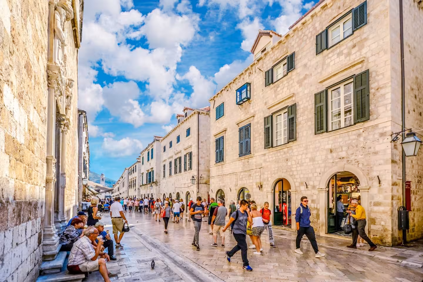 Stradun promenade in Dubrovnik Old Town with limestone streets and shops, key stop on Split day tour
