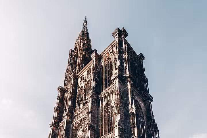 Gothic spire of Strasbourg Cathedral towering against a clear blue sky