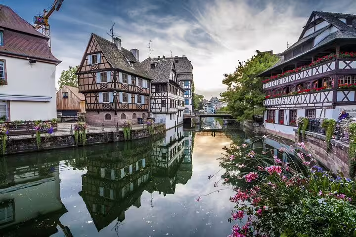 Half-timbered houses reflecting in Strasbourg canal waterway in Petite France historic district