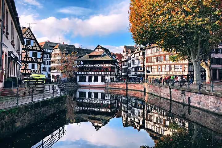 Half-timbered houses reflecting in Strasbourg canal in Petite France district on a sunny autumn day