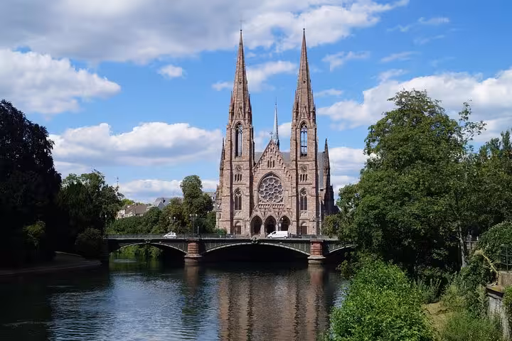 Gothic Saint Paul's Church with twin spires reflected in the Ill River, Strasbourg, France