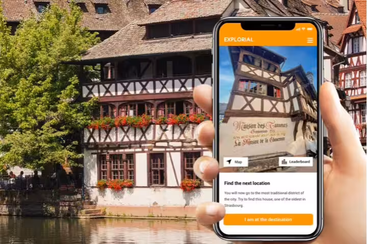 Phone app guiding Strasbourg scavenger hunt walking tour by Petite France half-timbered houses and canal