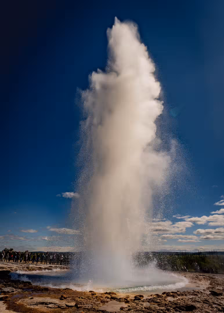Strokkur geyser erupting dramatically into blue sky on Iceland Golden Circle private day tour from Reykjavik