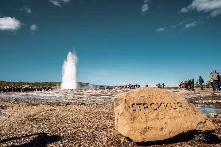Strokkur geyser erupting on Iceland's Golden Circle with tourists watching nearby