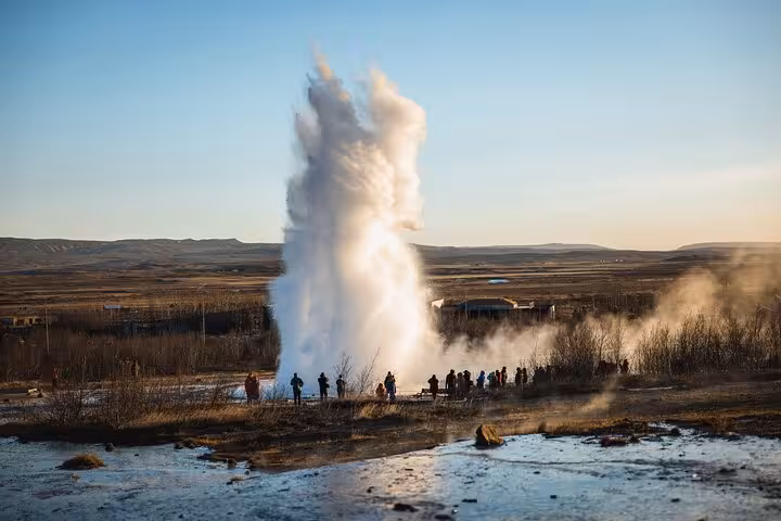 Strokkur geyser erupting on Iceland's Golden Circle with tourists watching nearby
