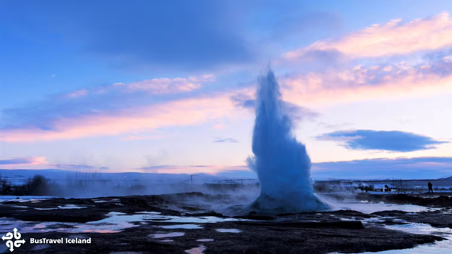 Strokkur geyser erupting at sunset during Golden Circle tour in Iceland