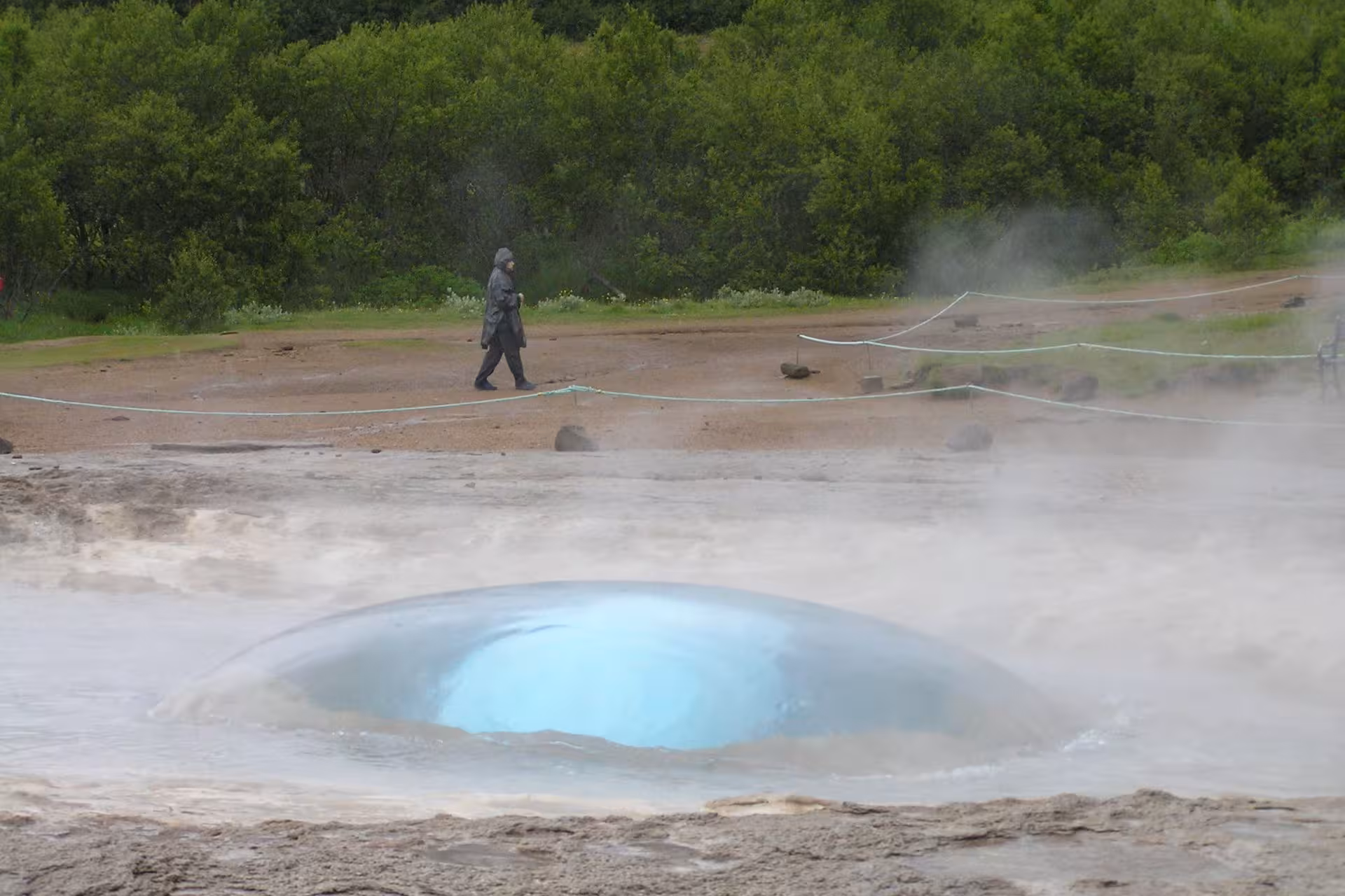 Strokkur geyser bubbling with turquoise water dome before eruption, Golden Circle Iceland