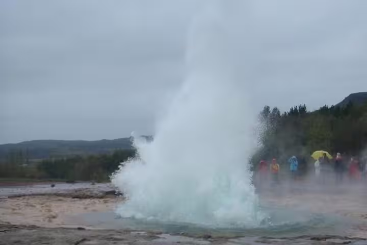 Strokkur geyser erupting on Iceland's Golden Circle with tourists watching nearby