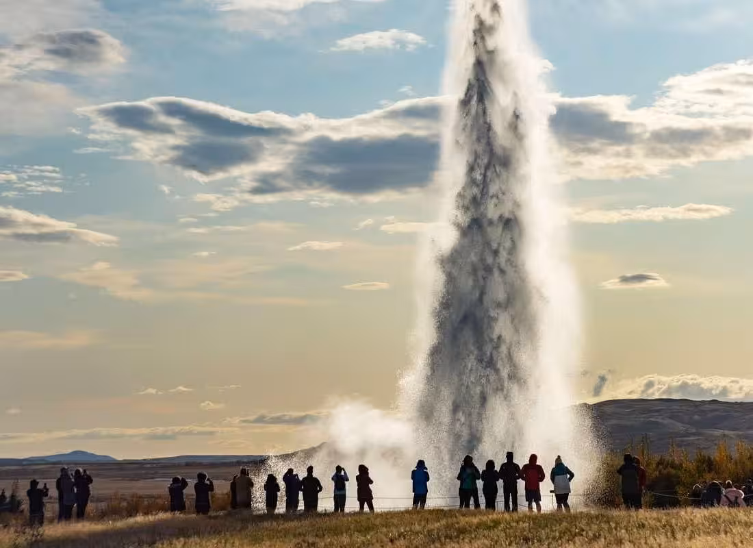 Tourists watching Strokkur geyser eruption on Iceland's Golden Circle tour
