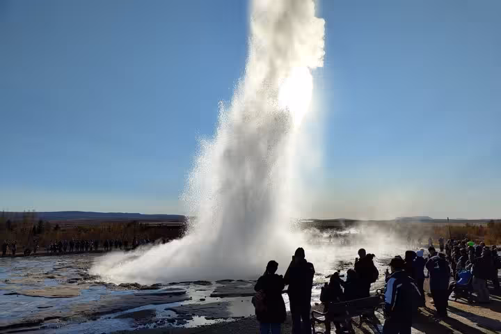 Strokkur geyser erupting on Iceland's Golden Circle with tourists watching