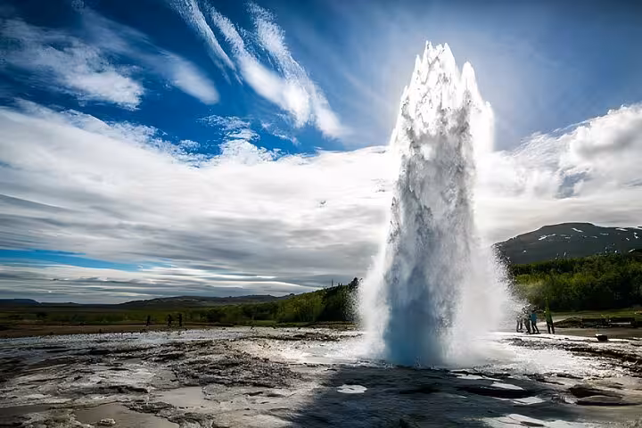 Strokkur geyser erupting on Iceland's Golden Circle with visitors watching nearby