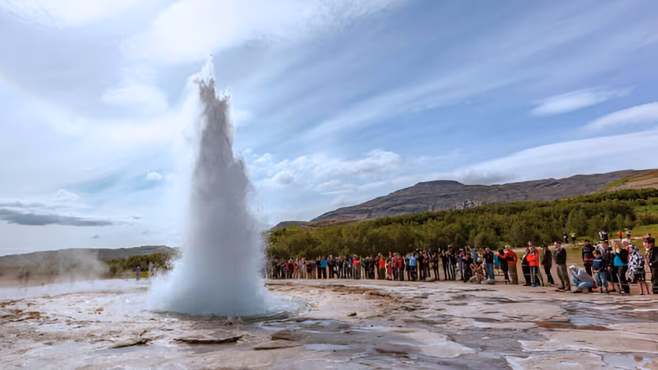 Strokkur geyser erupting on Iceland's Golden Circle with tourists watching nearby