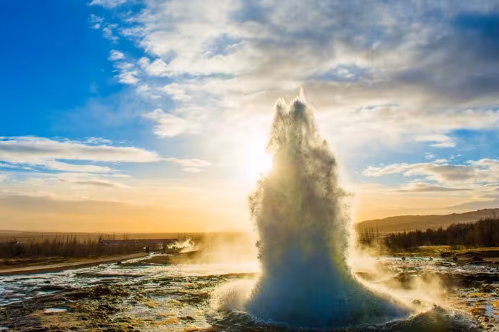 Strokkur geyser erupting at sunset in Iceland's Golden Circle geothermal area