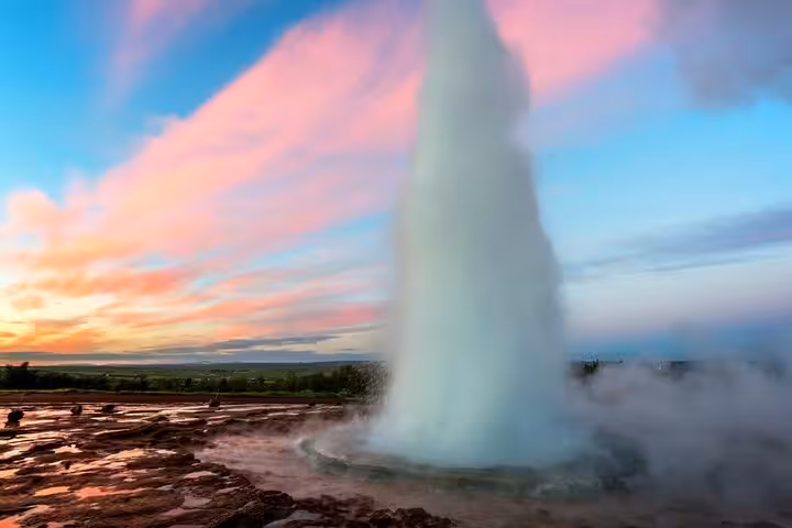 Strokkur geyser erupting at sunset on Iceland's Golden Circle route
