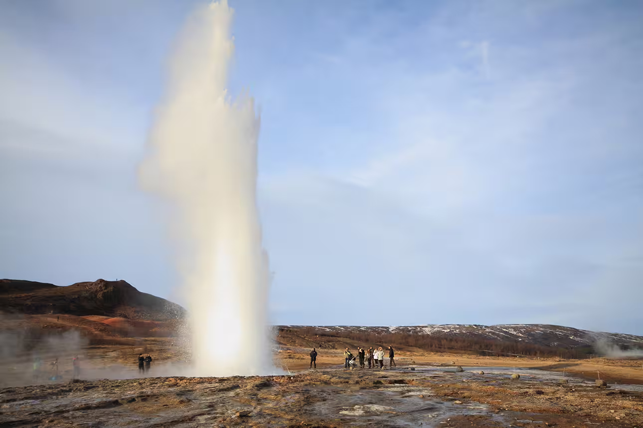 Strokkur geyser erupting on Iceland's Golden Circle with tourists watching nearby