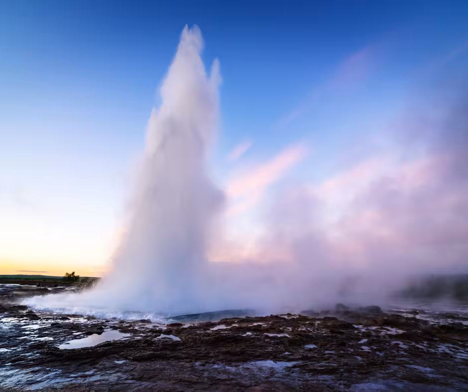 Strokkur geyser erupting at sunset on Iceland's Golden Circle route